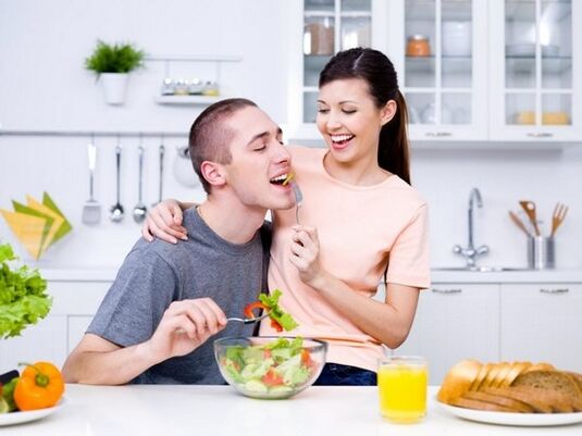 The girl feeds her man with potency-enhancing products